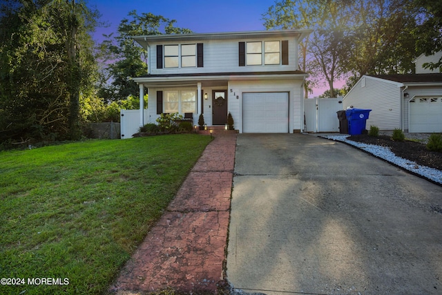 view of property with a lawn and a garage