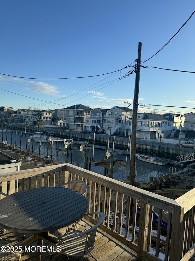 wooden terrace featuring a water view