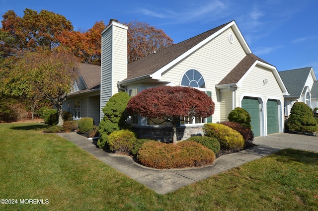 view of home's exterior featuring a lawn and a garage