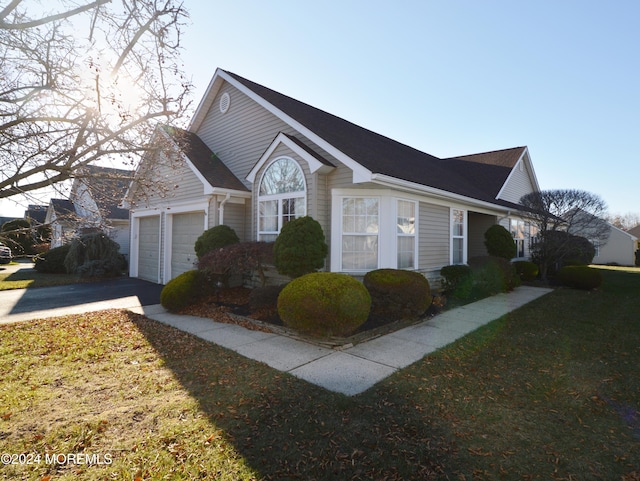 view of home's exterior with a garage and a yard