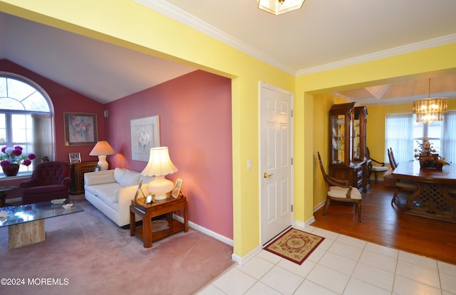 living room featuring crown molding, light tile patterned flooring, lofted ceiling, and an inviting chandelier