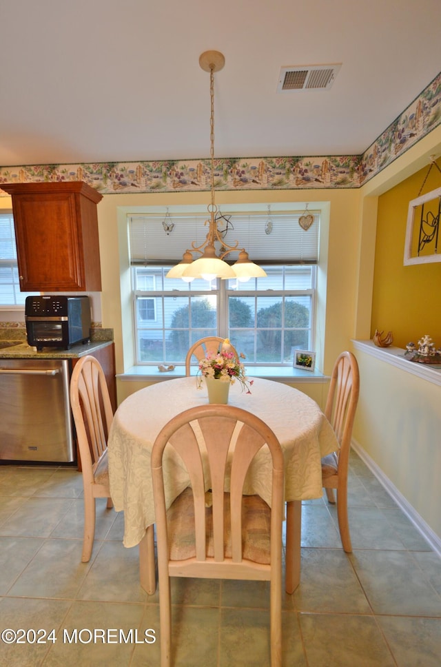 dining area with plenty of natural light and light tile patterned floors