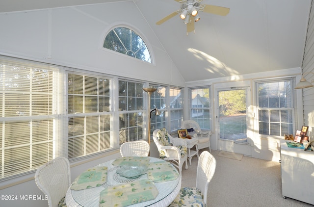 sunroom / solarium featuring ceiling fan, a wealth of natural light, and vaulted ceiling