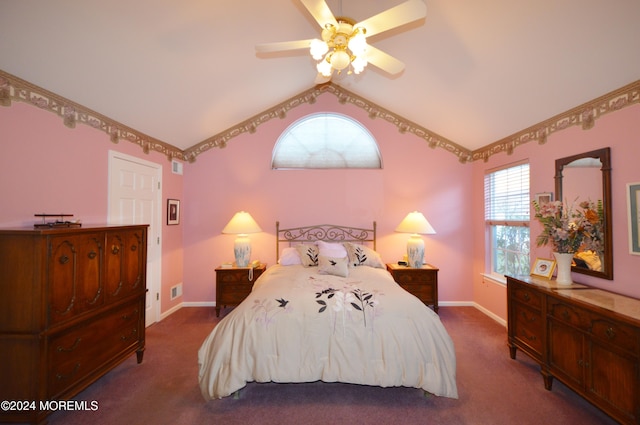 bedroom with dark colored carpet, vaulted ceiling, and ceiling fan