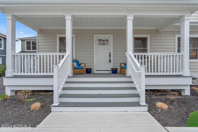 view of exterior entry with a porch