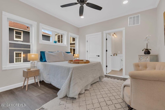 bedroom featuring wood-type flooring, connected bathroom, ceiling fan, and ornamental molding