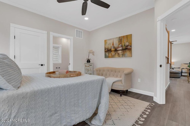 bedroom with ceiling fan, wood-type flooring, and ornamental molding