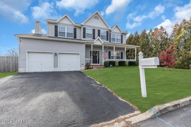 view of front of home with a porch, a garage, and a front lawn