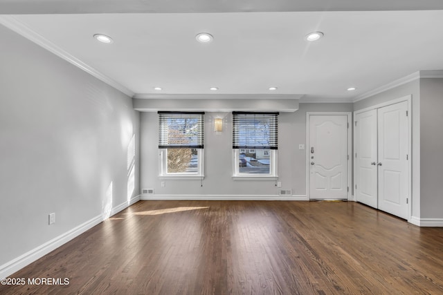 spare room with crown molding and dark wood-type flooring