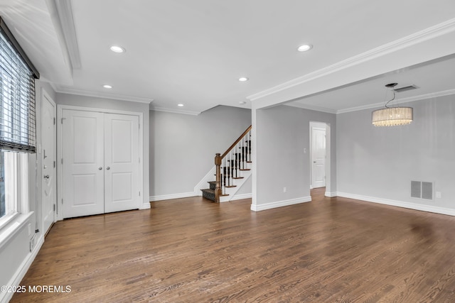 interior space featuring dark hardwood / wood-style floors, ornamental molding, and a chandelier