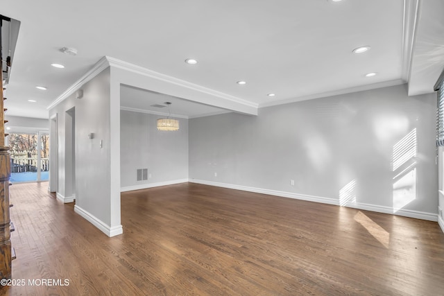 unfurnished room with a notable chandelier, dark hardwood / wood-style flooring, and crown molding