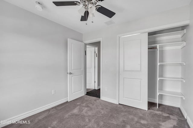 unfurnished bedroom featuring carpet flooring, ceiling fan, and a closet