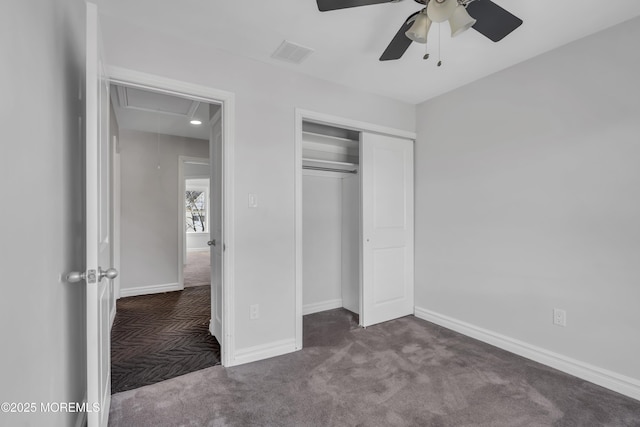 unfurnished bedroom featuring ceiling fan, a closet, and dark colored carpet