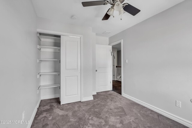 unfurnished bedroom with carpet flooring, ceiling fan, and a closet