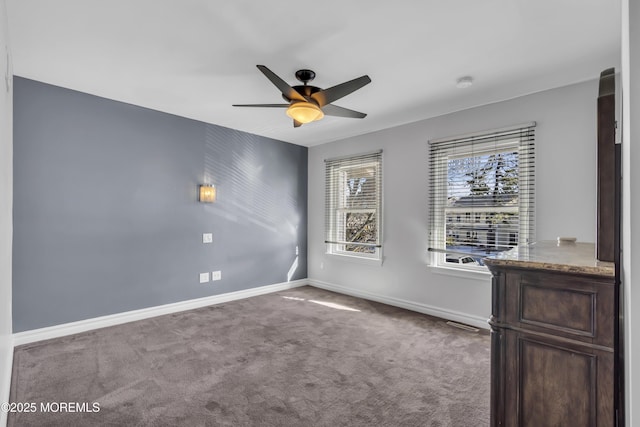 empty room with ceiling fan and carpet floors