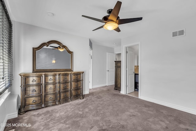 unfurnished bedroom featuring light carpet, ensuite bath, and ceiling fan