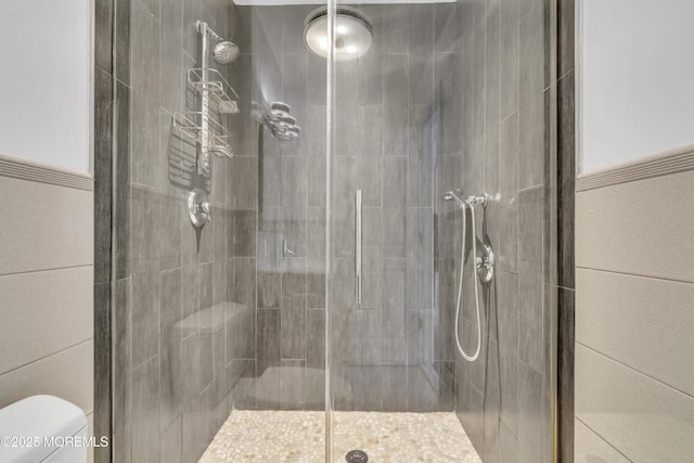 bathroom with an enclosed shower and toilet