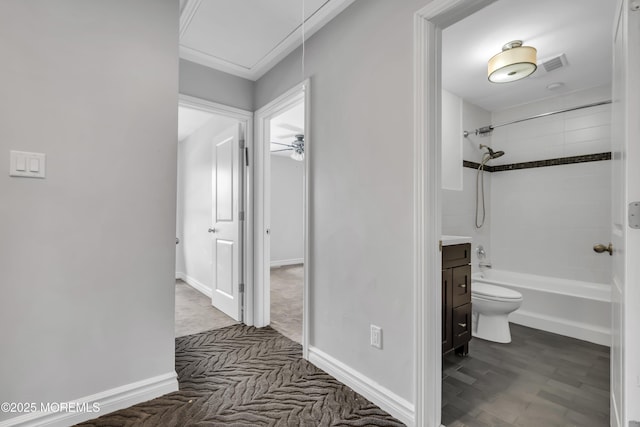 full bathroom featuring vanity, ceiling fan, hardwood / wood-style flooring, toilet, and tiled shower / bath