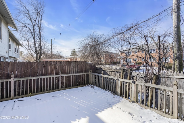 view of yard layered in snow