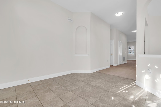 unfurnished room featuring light tile patterned floors