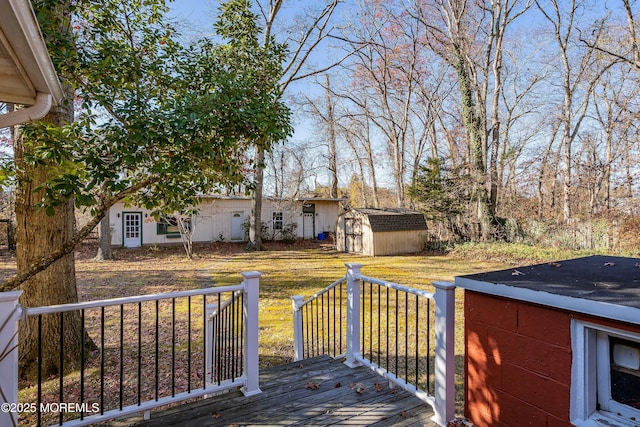 deck with a yard and a shed