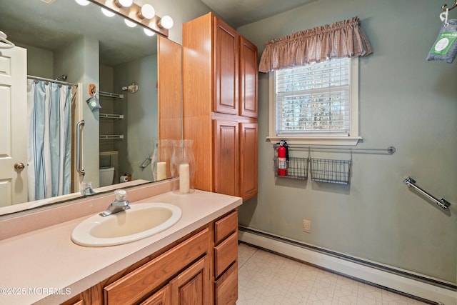 bathroom with a shower with curtain, vanity, toilet, and a baseboard heating unit