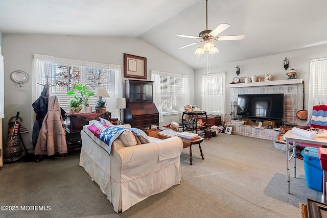 living room with ceiling fan, carpet floors, and vaulted ceiling