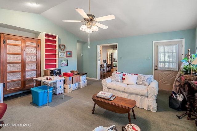 carpeted living room with vaulted ceiling and ceiling fan