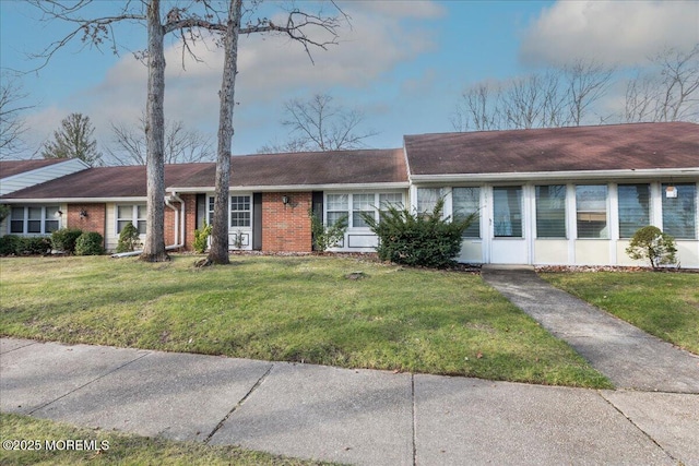 ranch-style house with a front lawn