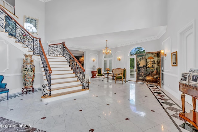 entryway featuring a chandelier and a high ceiling