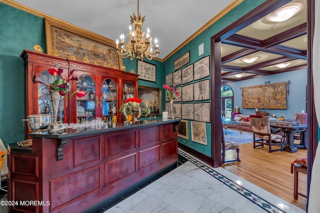 bar featuring coffered ceiling, crown molding, beam ceiling, a chandelier, and hanging light fixtures