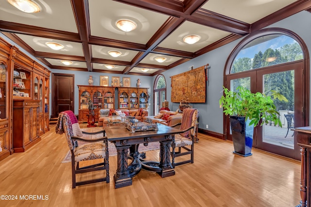 dining space featuring french doors, light hardwood / wood-style floors, coffered ceiling, and beam ceiling