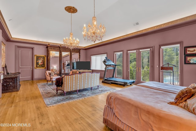 bedroom with access to outside, french doors, light wood-type flooring, ornamental molding, and a notable chandelier