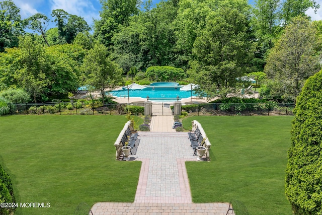 view of pool featuring a lawn