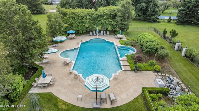 view of swimming pool featuring a patio area and a lawn