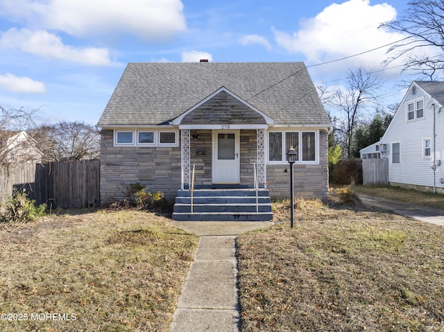 bungalow-style home featuring a front lawn