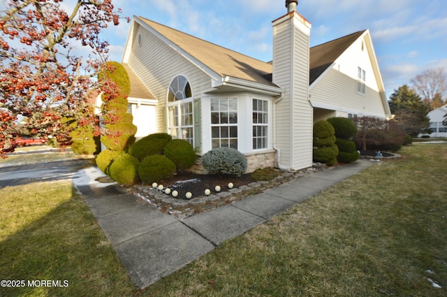 view of side of home with a yard