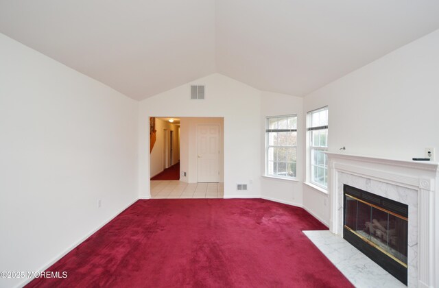 unfurnished living room featuring light colored carpet, a fireplace, and vaulted ceiling