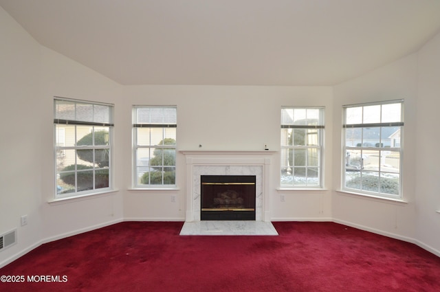 unfurnished living room with carpet flooring, a fireplace, and vaulted ceiling