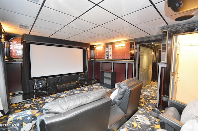 carpeted home theater room with wooden walls