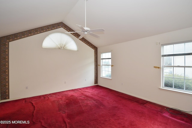 carpeted spare room with vaulted ceiling and ceiling fan