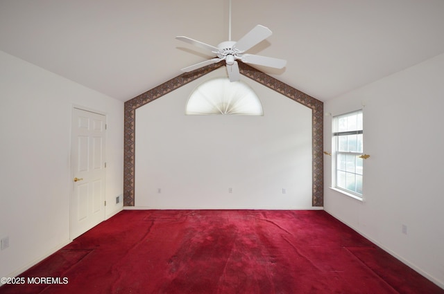 carpeted empty room with ceiling fan and lofted ceiling