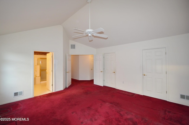 unfurnished bedroom with carpet, ceiling fan, connected bathroom, and vaulted ceiling