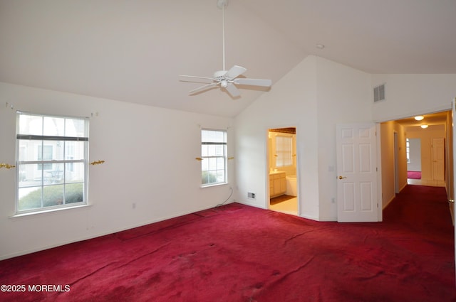 unfurnished bedroom featuring connected bathroom, ceiling fan, carpet floors, and high vaulted ceiling