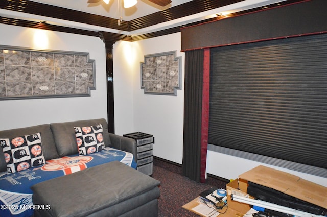 carpeted living room with decorative columns, ceiling fan, and crown molding