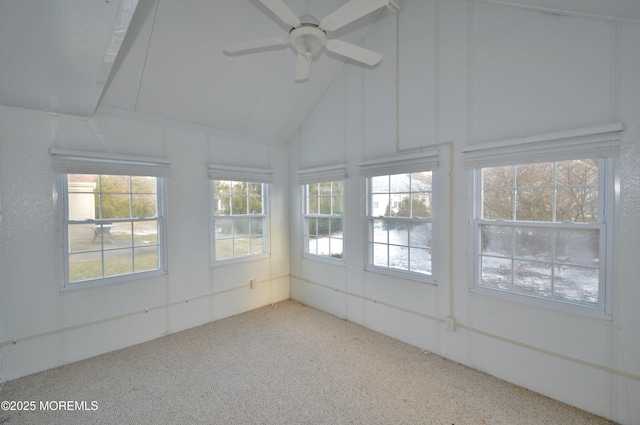 unfurnished sunroom with ceiling fan and vaulted ceiling