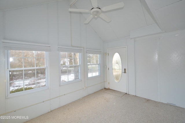 unfurnished sunroom with ceiling fan, a healthy amount of sunlight, and vaulted ceiling