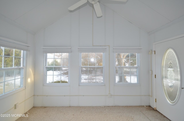 unfurnished sunroom with lofted ceiling, ceiling fan, and a healthy amount of sunlight