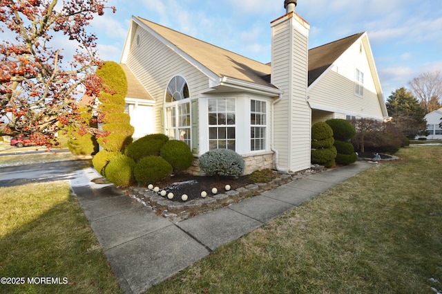 view of property exterior with a lawn