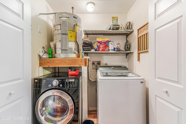 laundry area featuring water heater and washer and dryer